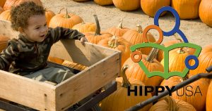 child in wagon at pumpkin farm